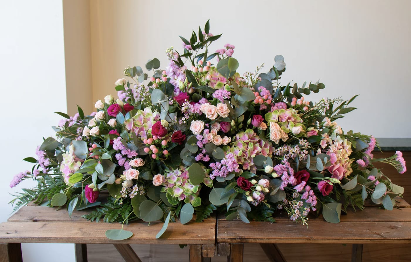 Casket Spray in shades of Pink - Our casket spray flowers are meticulously crafted arrangements specifically designed to rest upon the casket during a funeral or memorial service.   This casket spray is designed in shades of pink.   PICTURED IS OUR STANDARD SIZE.