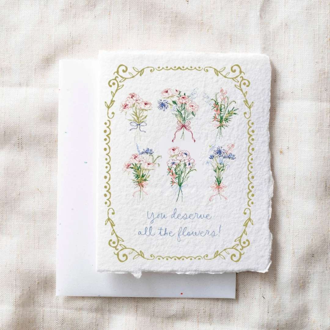 Decorative card with small illustrated flower bouquets and the words "you deserve all the flowers!"