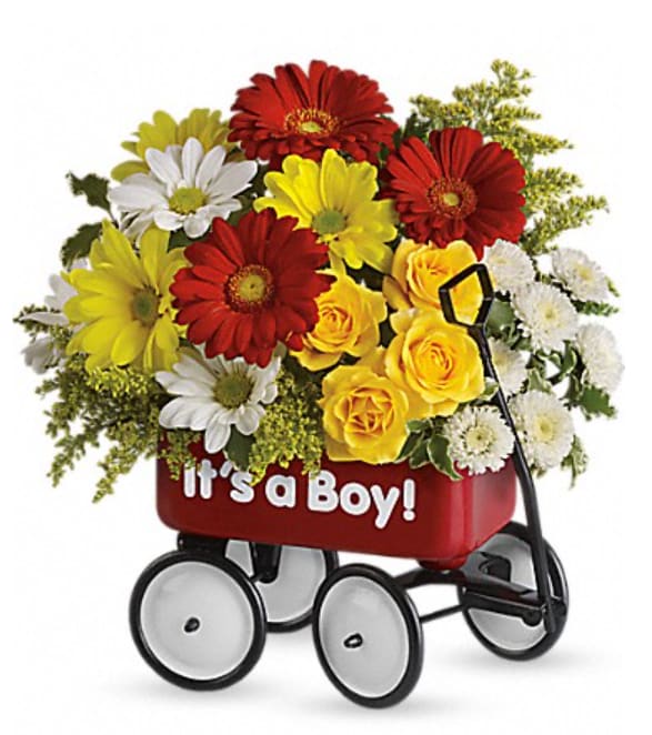 Mixed flower arrangement in a red wagon with "It's a Boy!" text