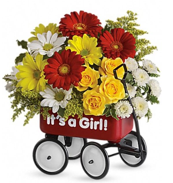 Flower arrangement in a red baby carriage with "It's a Girl!" text