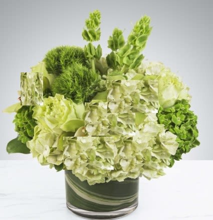 Green hydrangea arrangement in a glass vase