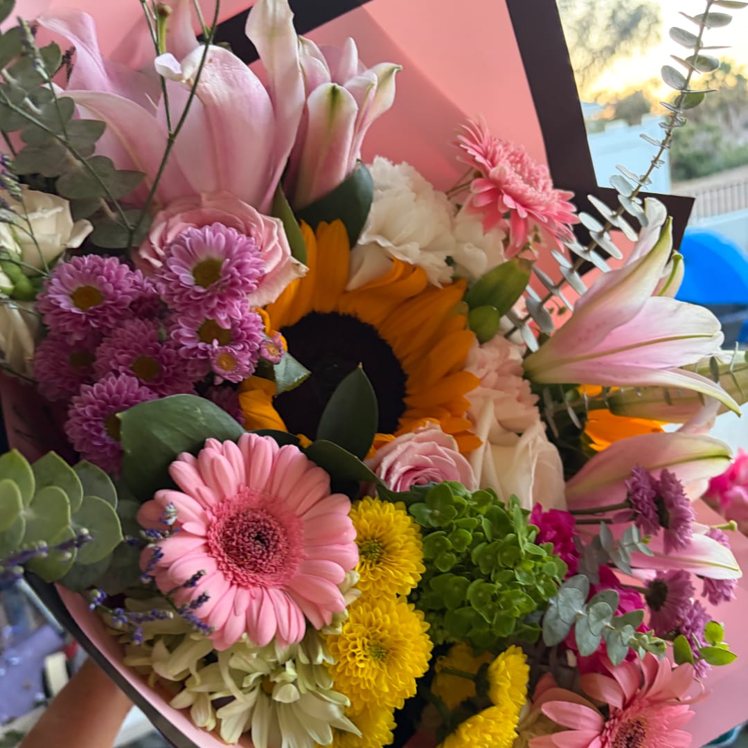 Mixed bouquet with a sunflower, pink lilies, gerbera daisies, and chrysanthemums