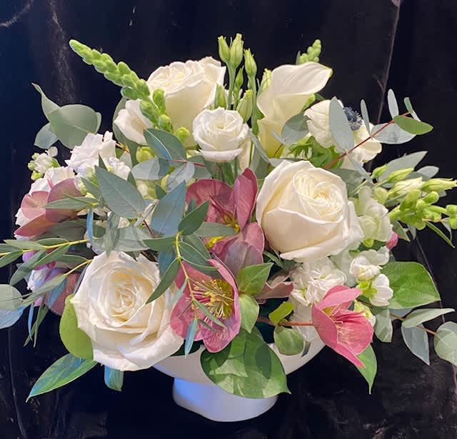 Painted Parasol  - Believe it or not, for me, the vase/container is the star of the show.  It is simple elegance at its finest.  A pure white contemporary designer bowl (ceramic) that resembles an inverted parasol is why I love it!  A mix of lavender roses, silvery greens, and every girls favorite, calla lilies, look gorgeous in this  lovely container.  The quality of the vase is so nice, it can be used as a decorative accent after the flowers have gone.   Bowl is 8" in diameter empty,  arrangement is approximately 14" wide filled with flowers.