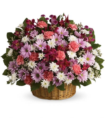 Basket arrangement of pink, purple, and white flowers