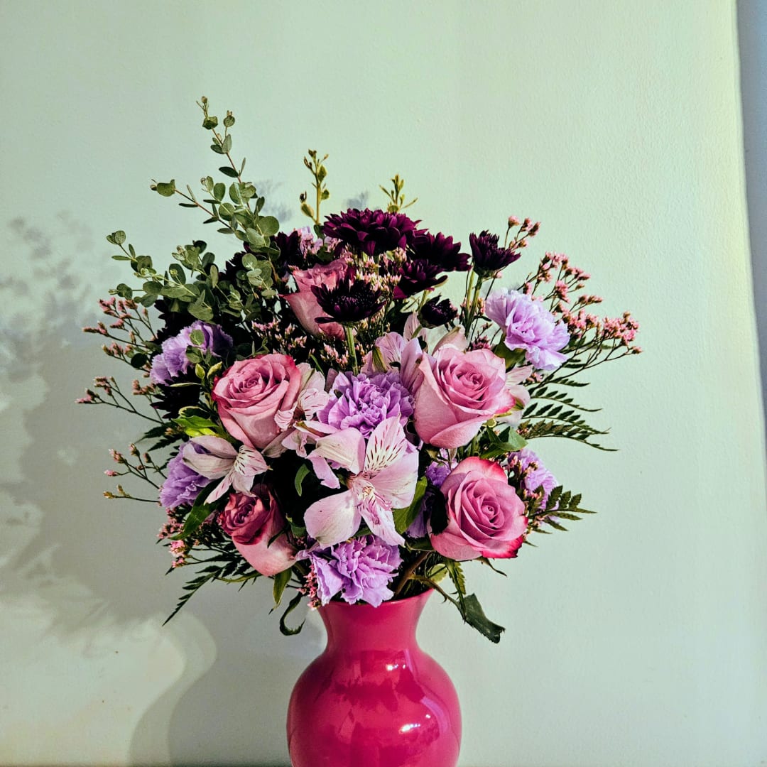 Pink and purple mixed bouquet in a bright pink vase