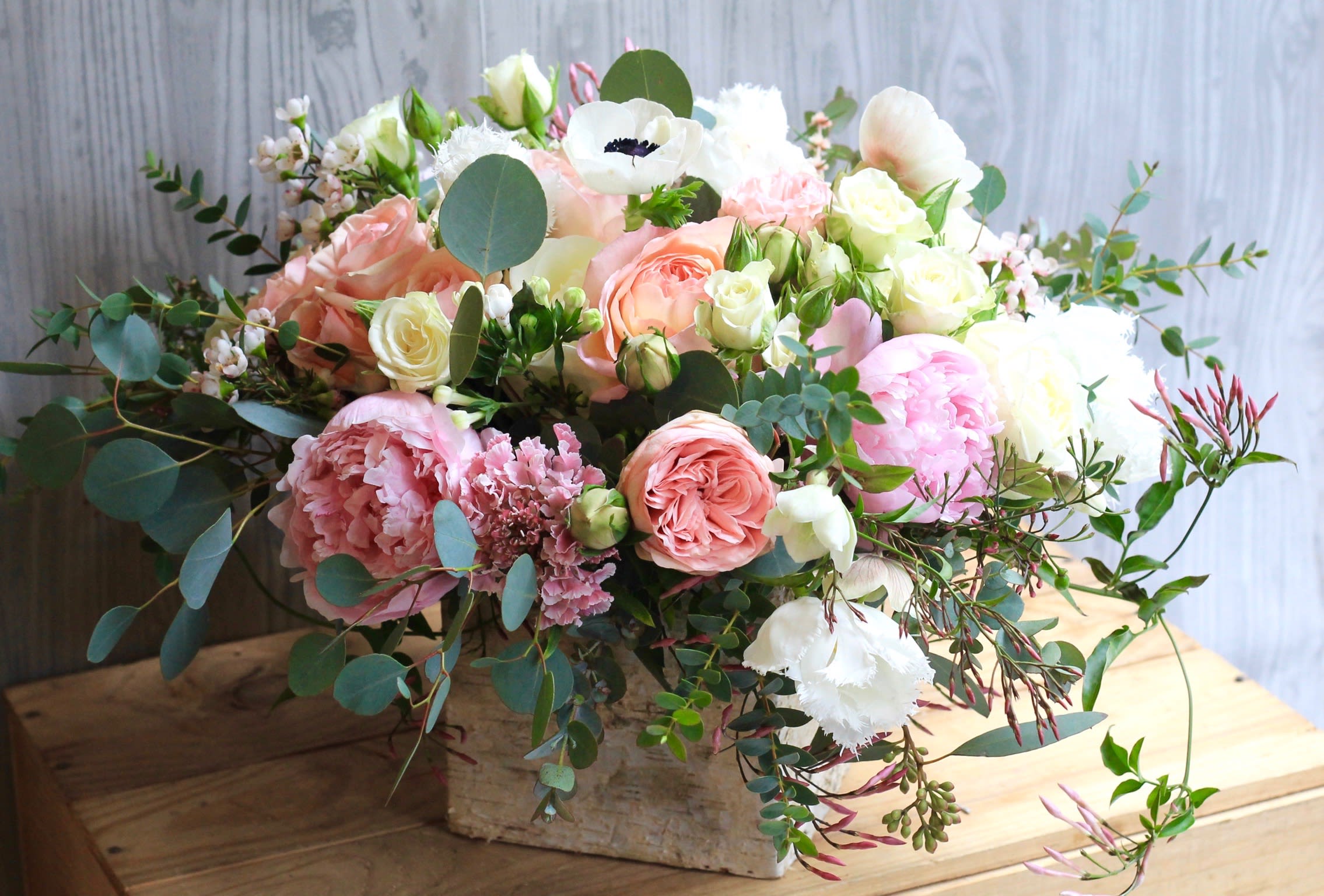 Mixed pastel bouquet in a rustic wooden box