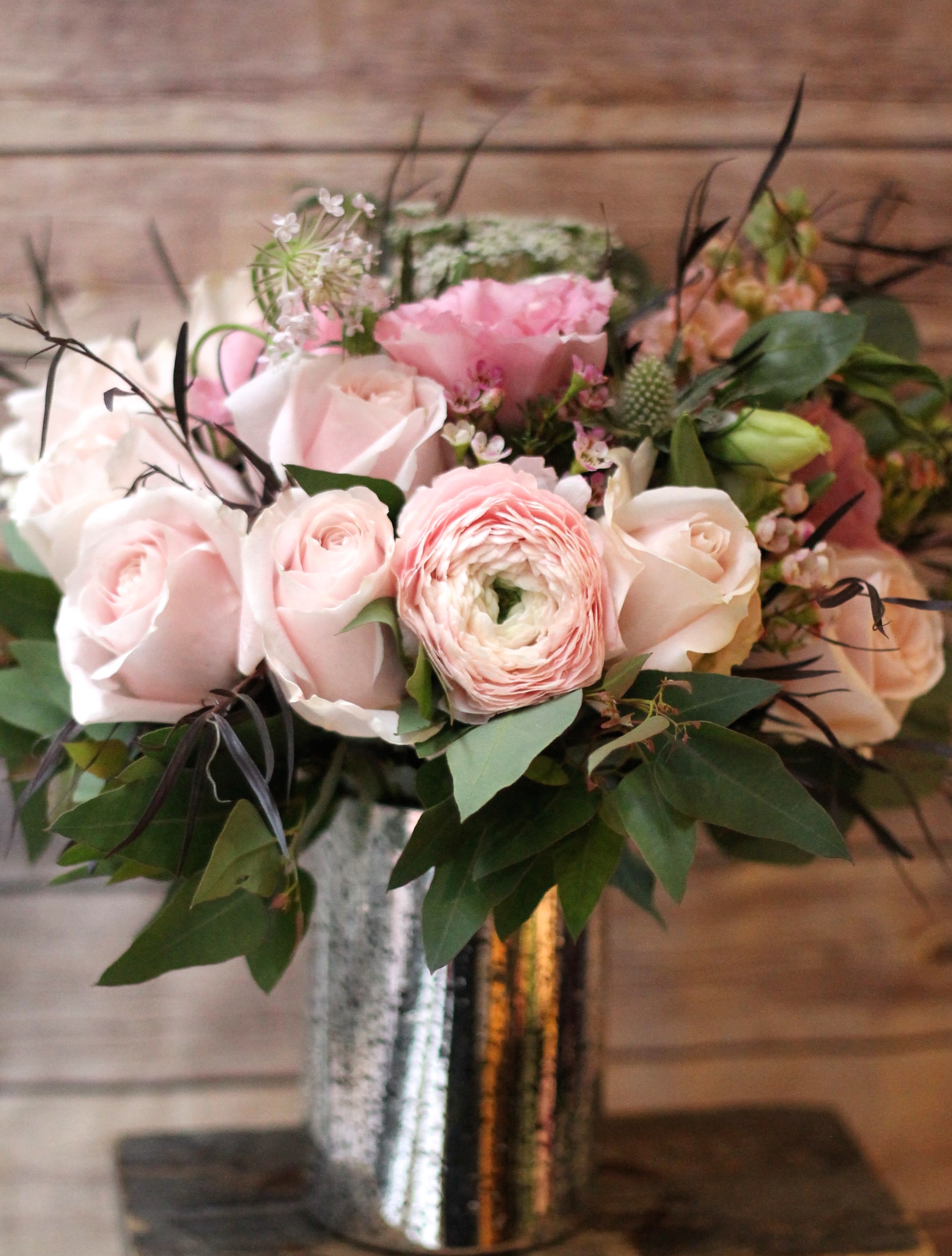 Pink and white flower bouquet in a metallic vase