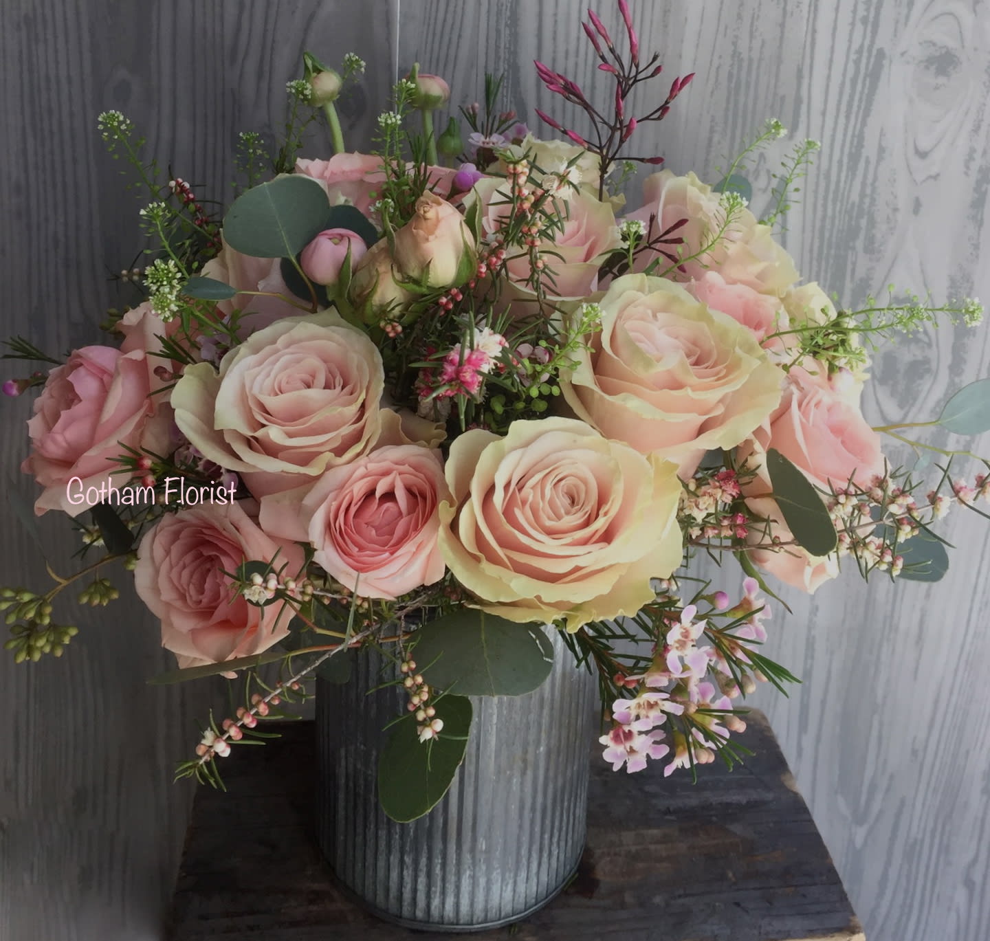 Pink and cream rose bouquet in a ribbed metal vase