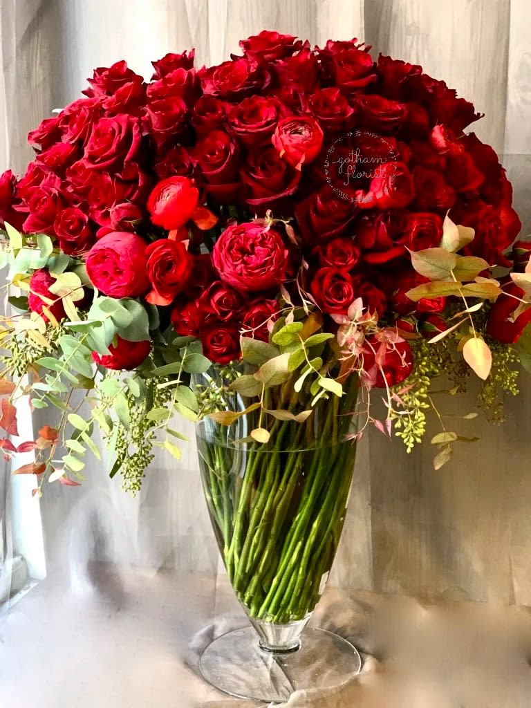 Large bouquet of red roses in a clear glass vase
