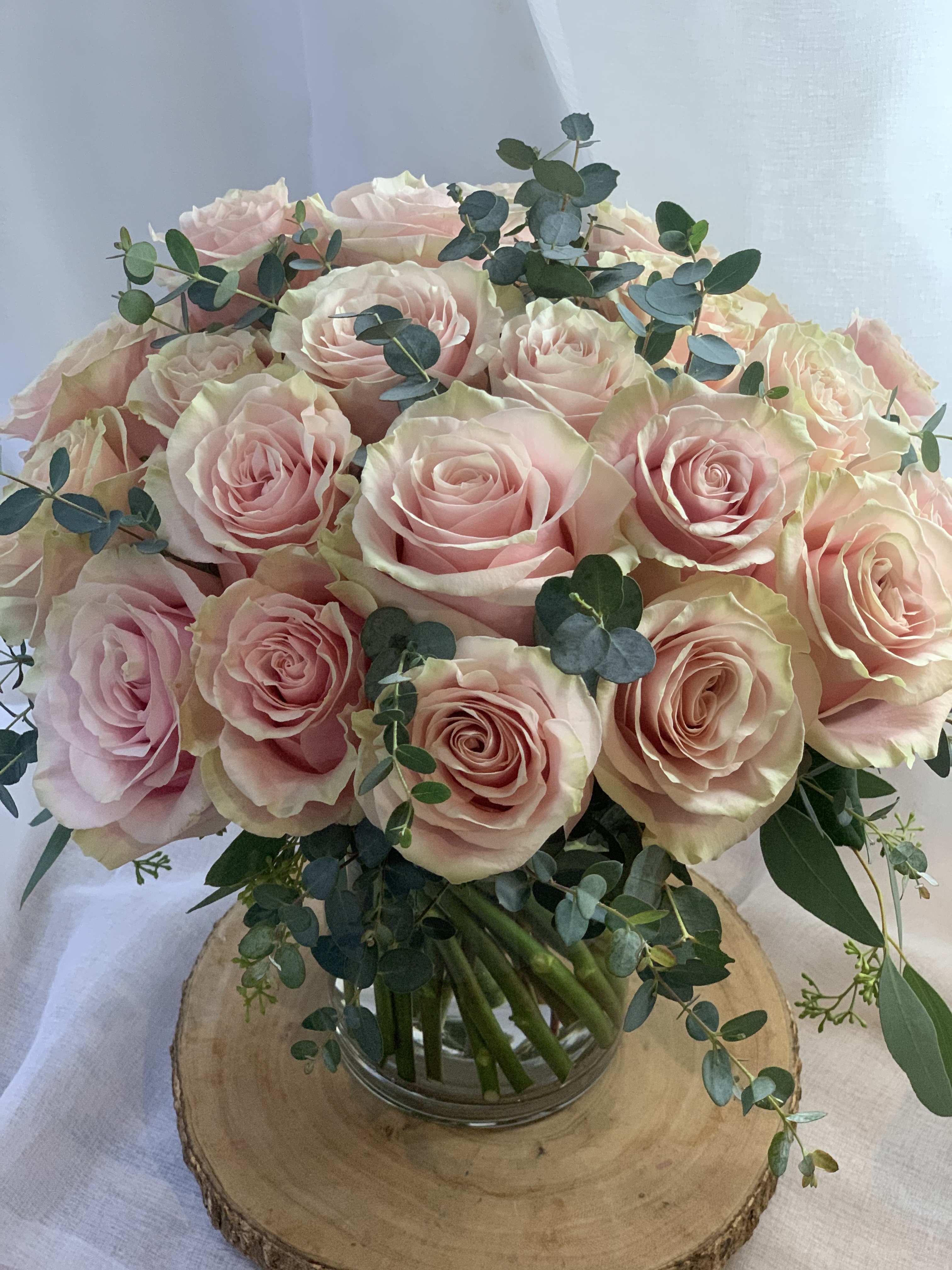 Bouquet of pale pink roses in a glass vase