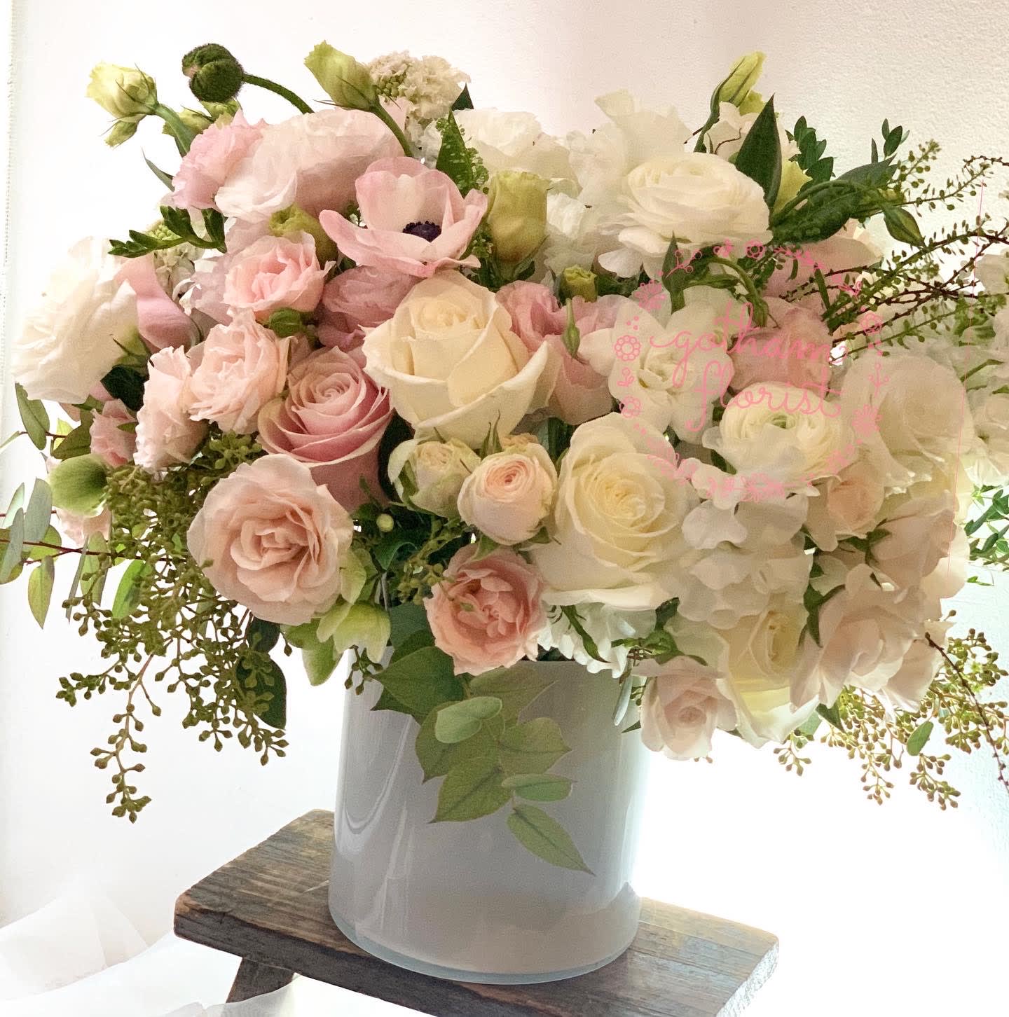 Blush and white rose bouquet in a white vase