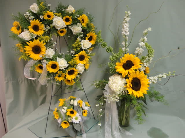 Sunflower and white rose floral arrangements with ribbon accents