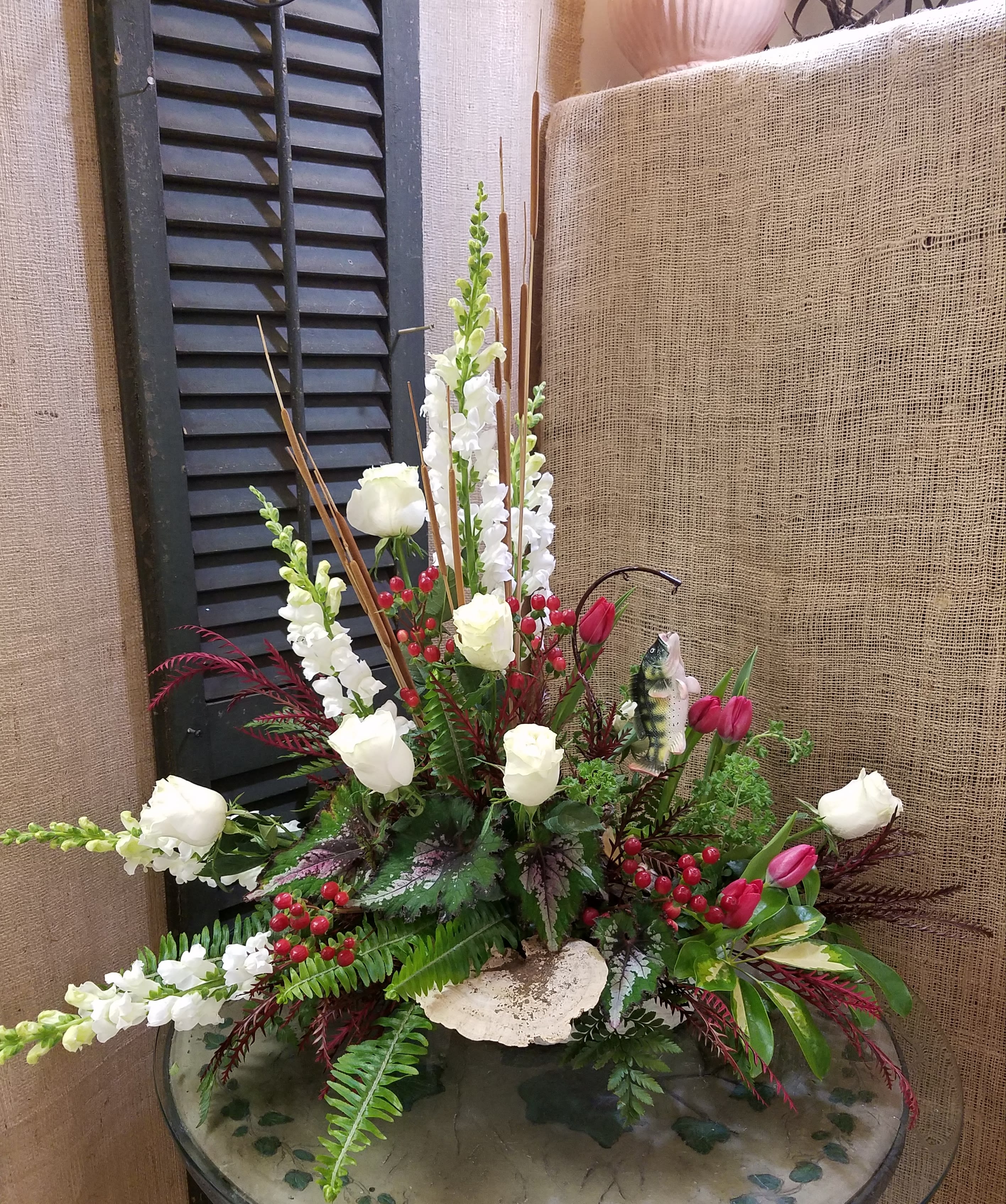Tall floral arrangement with white roses, white snapdragons, and pink tulips