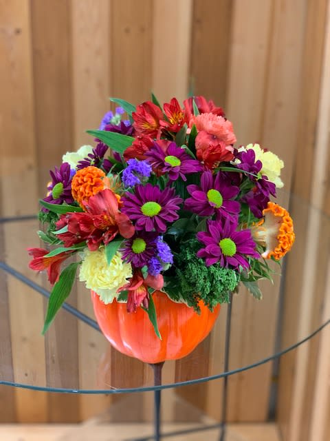 Mixed bouquet in an orange pumpkin-shaped vase