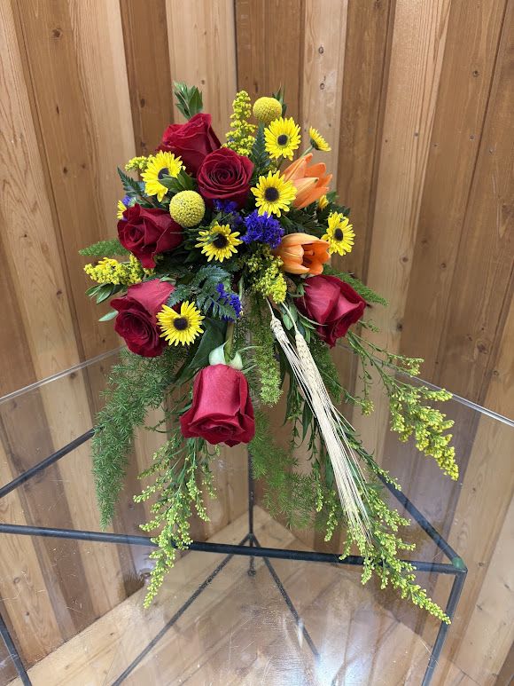 Bouquet of red roses, yellow daisies, and orange lilies
