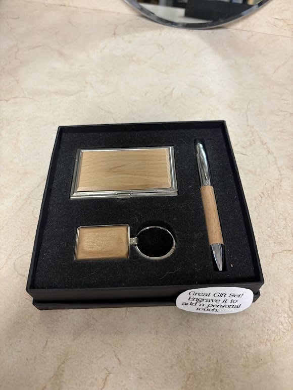 Gift set with a compact mirror, keychain, and pen in a black box
