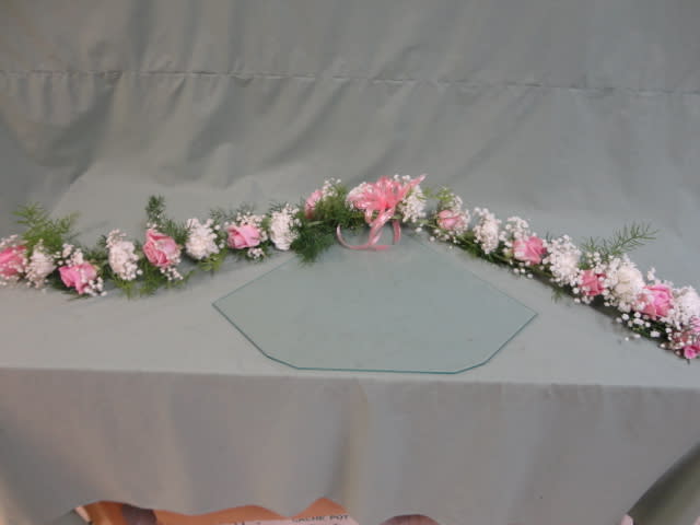 Long pink and white floral garland with a ribbon bow