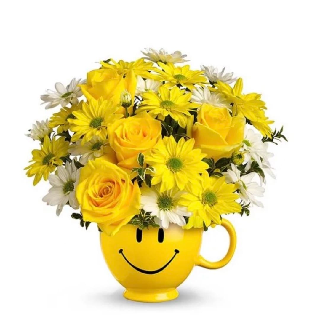 Yellow roses and daisies arranged in a smiley-face mug