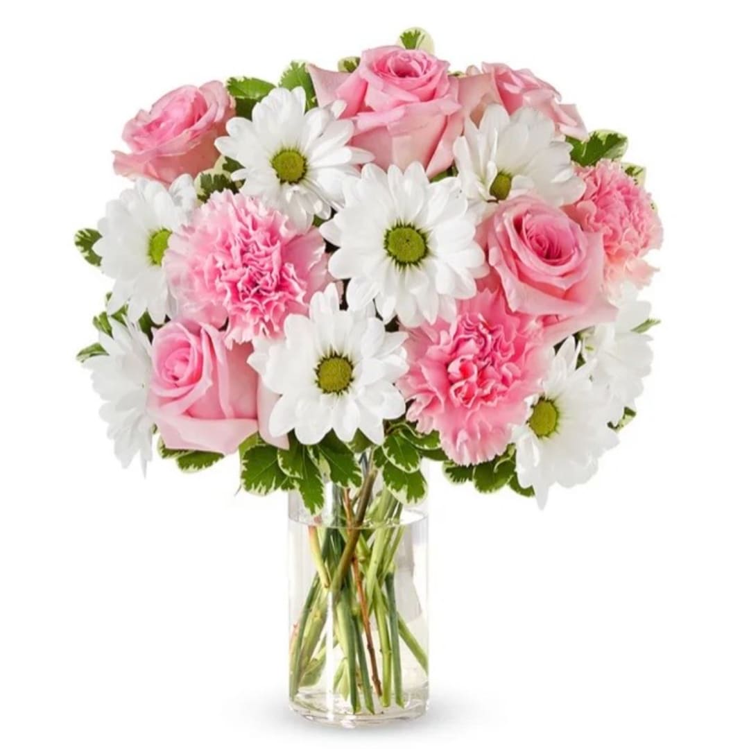 Pink roses and white daisies arranged in a clear glass vase