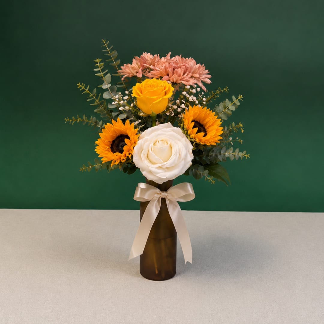 Bouquet of roses and sunflowers in a brown vase with a ribbon