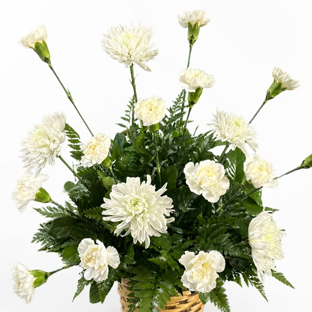 White carnations and chrysanthemums in a woven basket