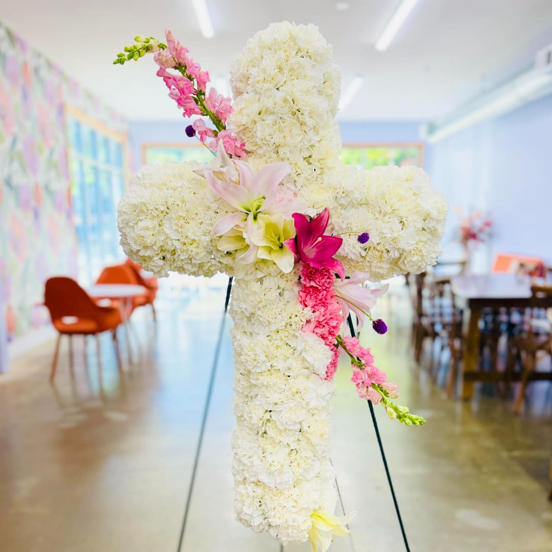 White floral cross with pink lilies and snapdragons