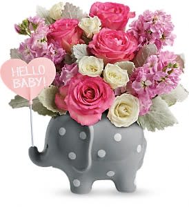 Pink and white roses in a gray elephant planter with a heart balloon