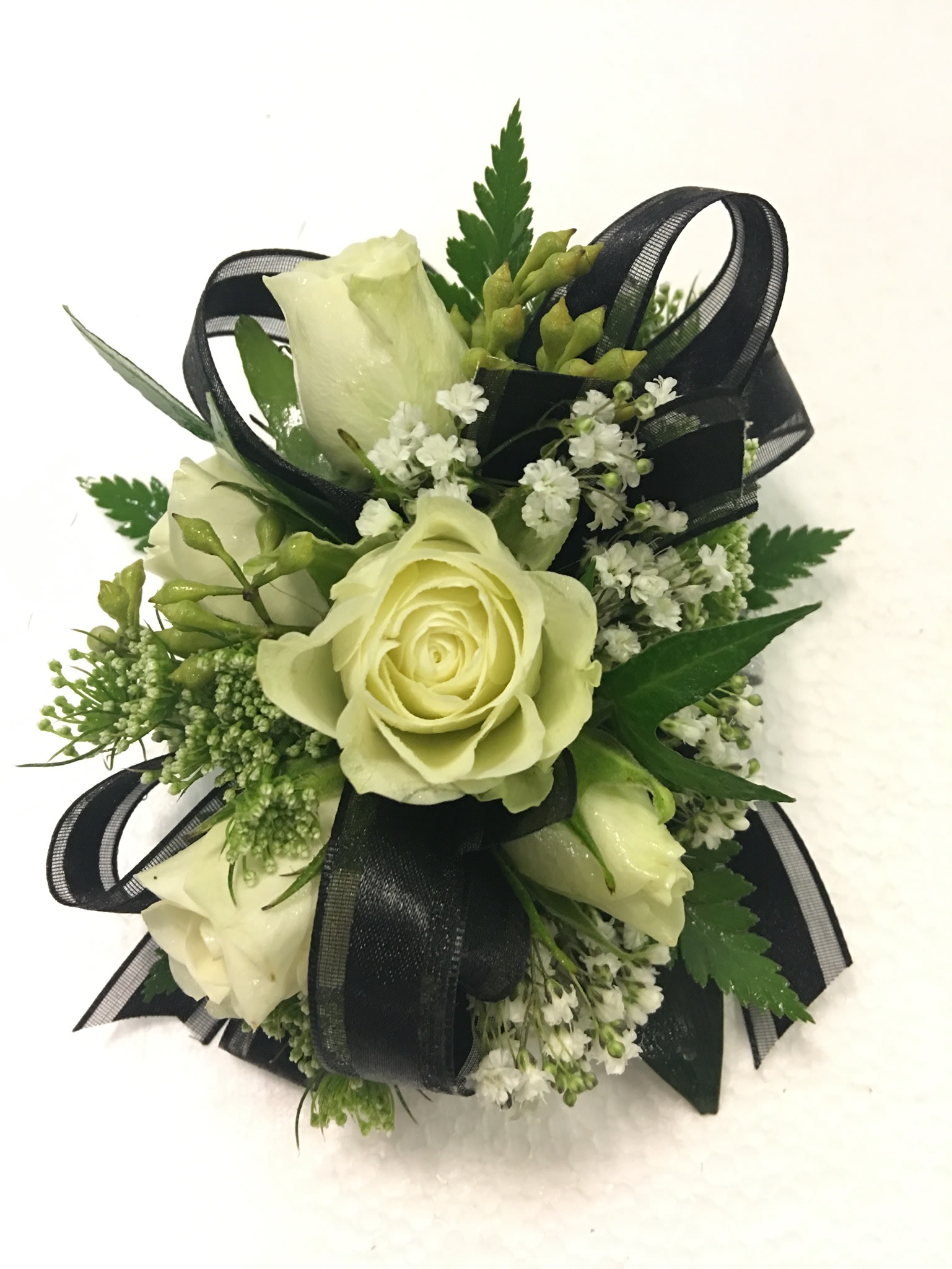 Small bouquet of pale roses with black ribbon accents