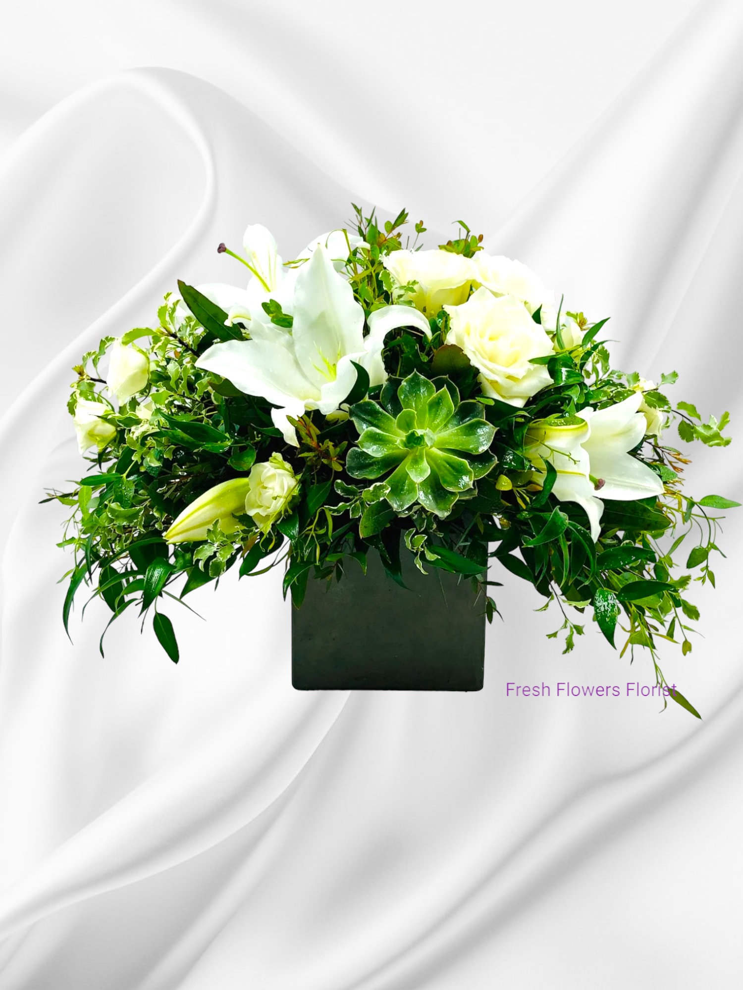 White lilies and roses in a black square vase