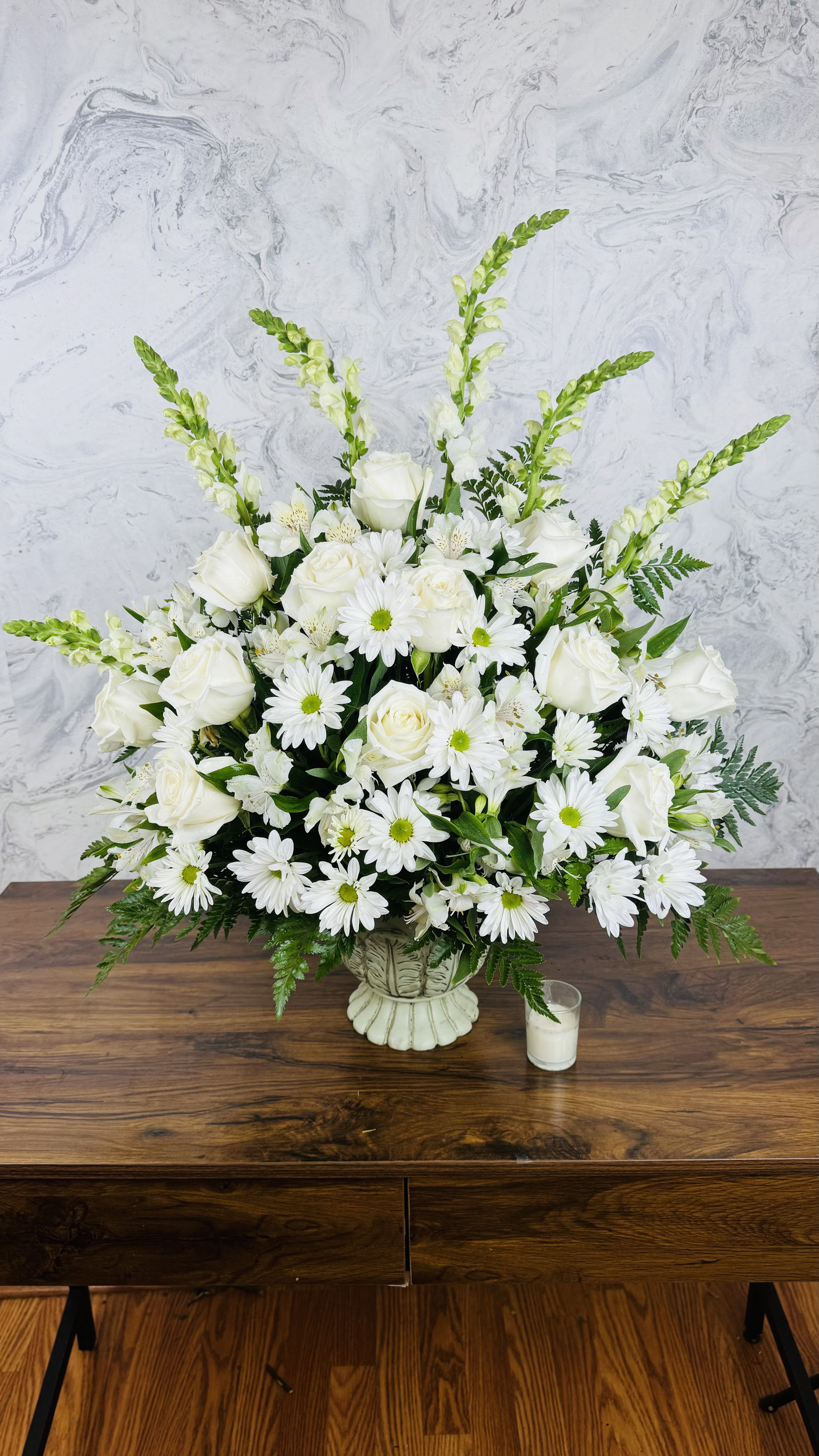 White roses and daisies in a low vase arrangement