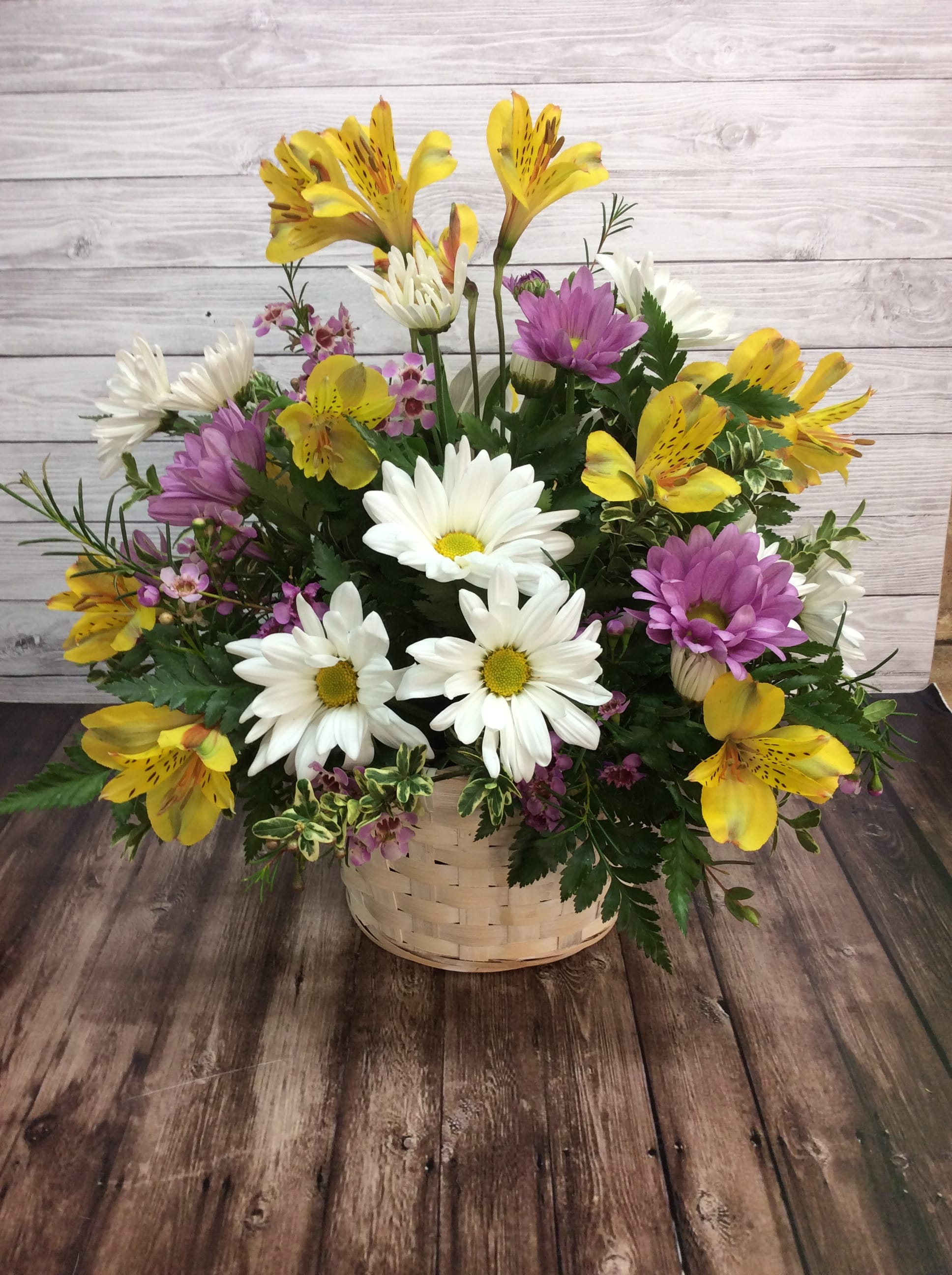 Basket of Fresh - A traditional white basket filled with daisies and alstroemeria lilies. *Colors may change due to availability* 