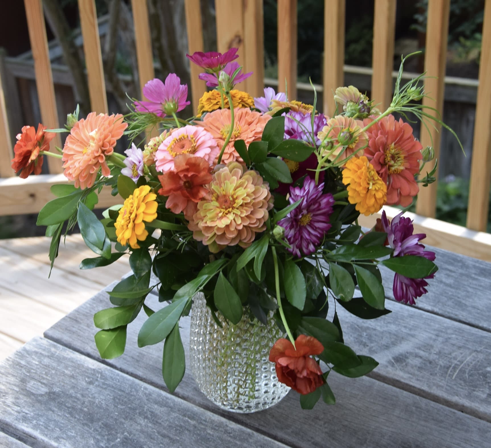 Mixed bouquet of colorful flowers in a clear glass vase