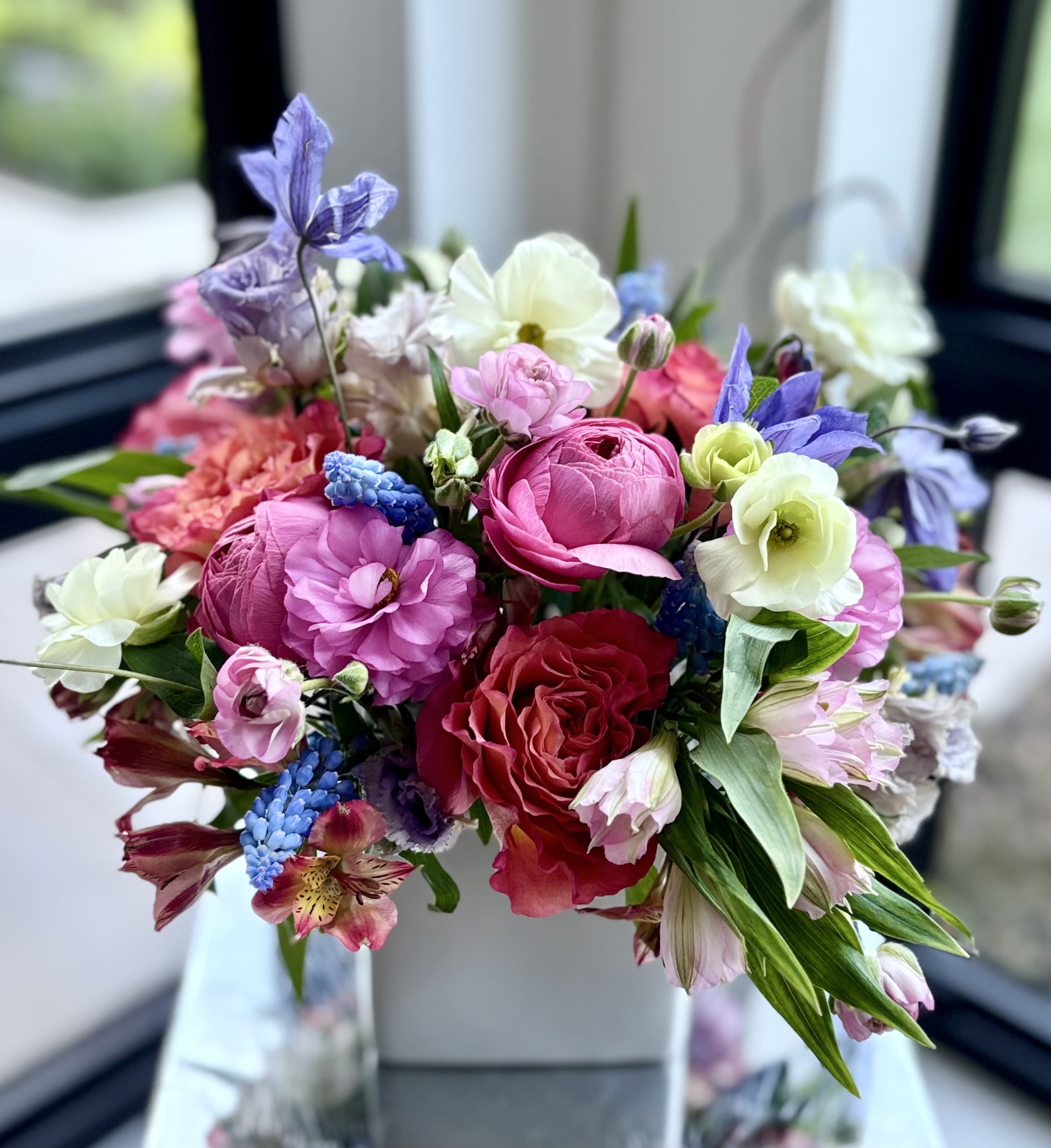 Floral Fling - An artful flower arrangement full of fun floral textures and colors, focused on hot pinks, oranges, blues and purples, softened with light green/creamy yellow. 