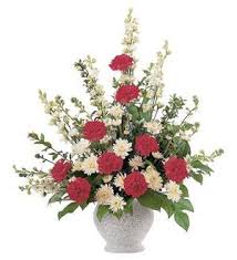 Red and white floral arrangement in a white vase