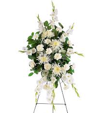 White floral standing spray on an easel