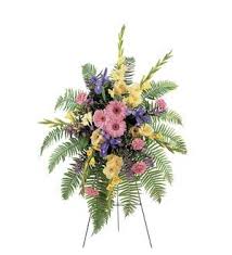 Standing floral spray with pink, yellow, and purple flowers