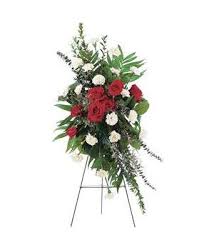 Standing floral spray with red and white flowers on an easel