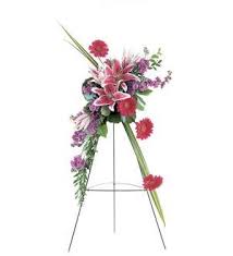 Standing floral spray with pink and purple flowers on an easel