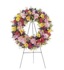 Large multicolored floral wreath on a metal stand
