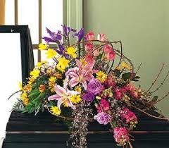 Colorful floral spray on a dark casket
