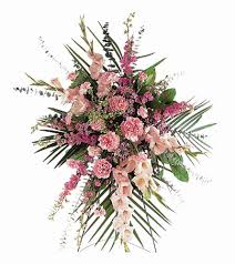 Pink floral spray with long palm fronds and mixed blossoms