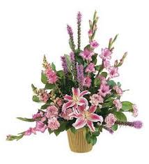 Pink lilies and mixed pink flowers in a gold vase