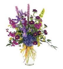 Colorful mixed flower bouquet in a clear glass vase