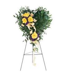 Heart-shaped floral spray on a standing easel with yellow roses