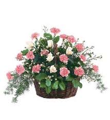 Pink and white flowers arranged in a wicker basket