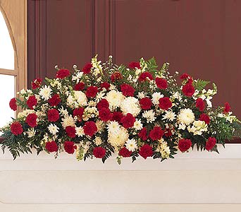 Red and white floral casket spray with mixed blooms