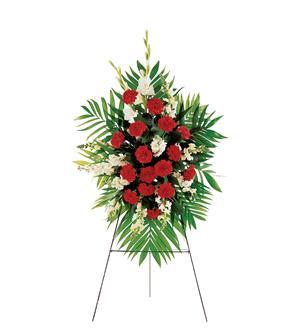 Standing floral spray with red and white flowers on an easel