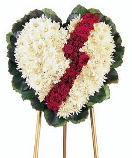 Heart-shaped funeral wreath with white flowers and a red rose diagonal