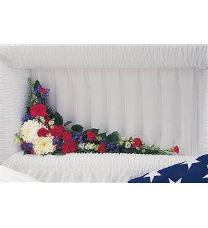 Casket spray with red, white, and blue flowers