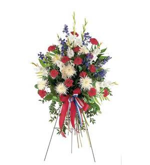 Standing floral spray with red, white, and blue flowers on an easel